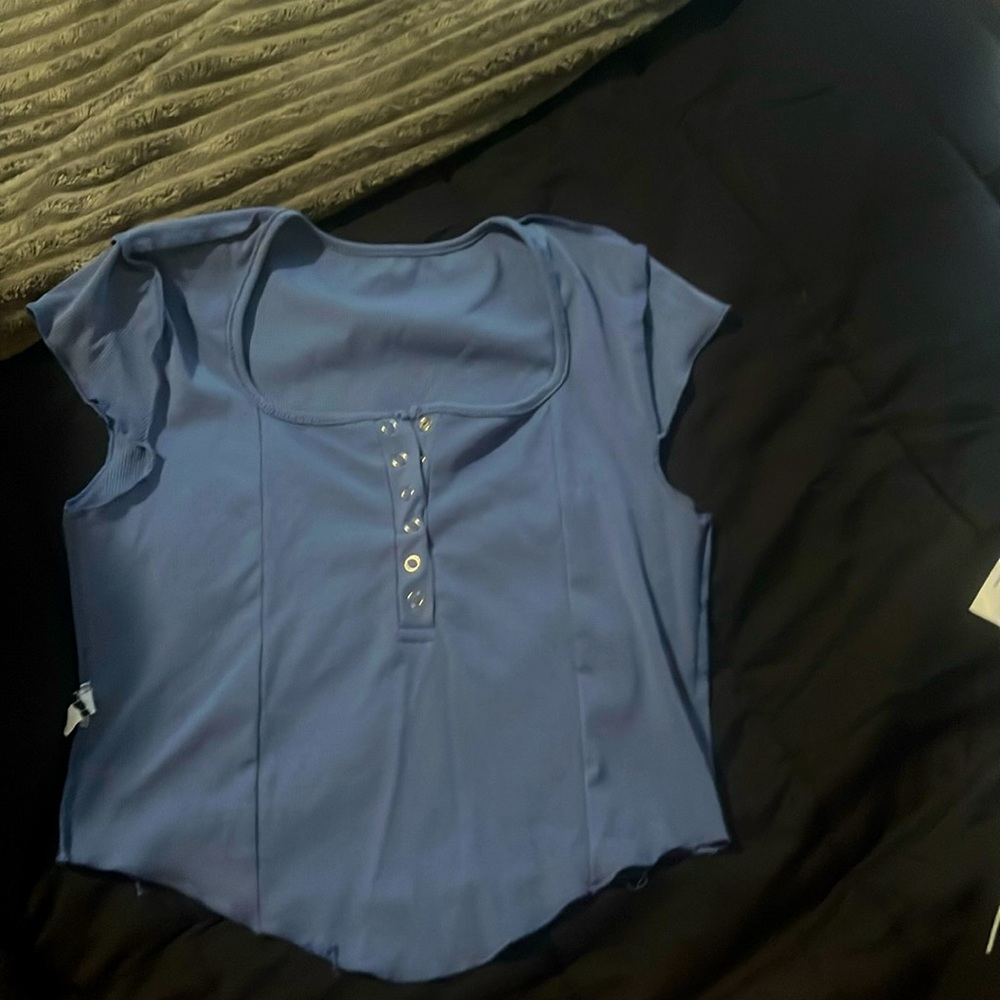 Large, light blue crop top with v cut at the bottom from Forever 21.